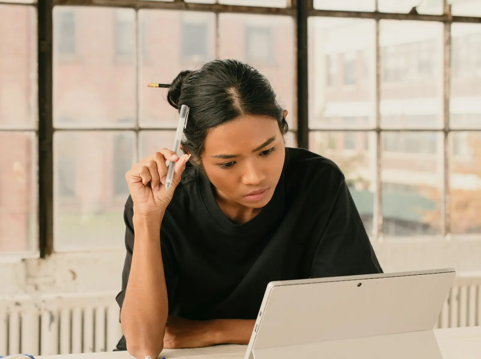 A stressed student studying at her tablet